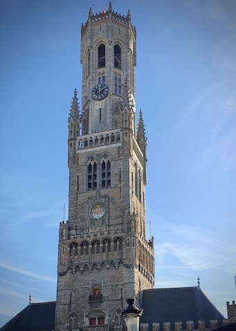 Bruggen kellotapulin torni ja sininen taivas takana.